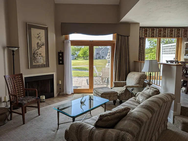 Formal living room, hinged glass door with transom to private patio, 2 steps to dining room