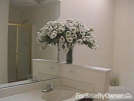 Master bathroom
						:
						Shower section is reflected on the mirror with the corner tub on the right.