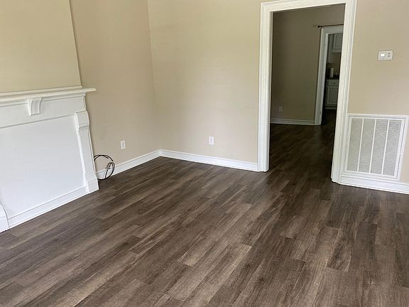 Beautifully renovated. Fresh paint, new luxury vinyl plank flooring. Charming accents like this original mantel.