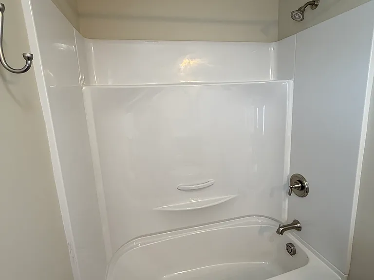 New tub unit features convenient built-in shelving. All fixtures new.