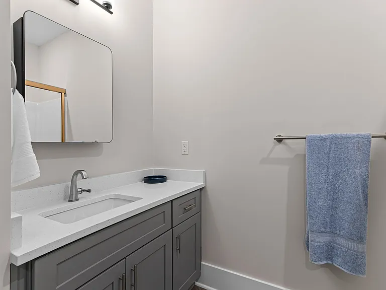 Active Adult bathroom with a sink and a mirror and a towel rack