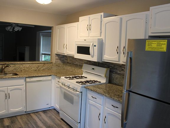 Kitchen with new paint and flooring and gas stove