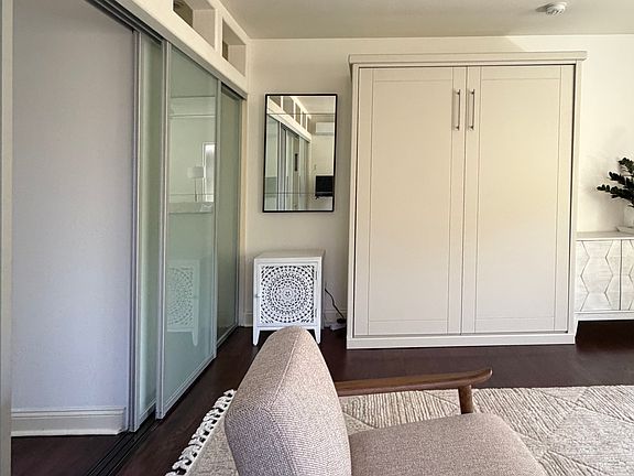 View of Cabinet bed with included side cabinet and mirror.