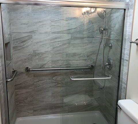 Stunning Shower Stall with Glass Sliding Doors and Grab Bars for your safety