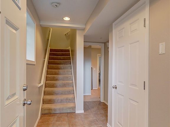 Lovely entry with a nice sized closet, access to the garage, a guest bedroom and stairway to the main level. 