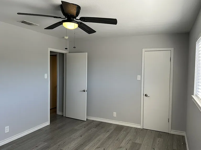 2nd bedroom nice large room. Closet is behind the closed door.