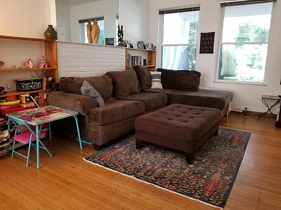 Custom shelving units on either side of a decorative fireplace. Wonderful big windows provide indoor/outdoor feel. New window blinds throughout the home also provide privacy and shade whenever preferred.
