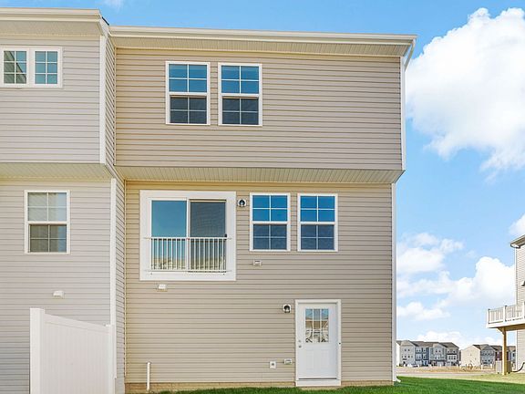 Back exterior view of the York II floor plan at South Brook Townhomes by DRB Homes, located in Inwoo