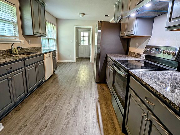 Kitchen with granite countertops, breakfast nook, laundry room