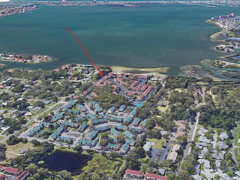 Overhead view of the complex as well as Boca Ciega Bay and Clam Bayou to the right (a fantastic kayaking area). Red arrow shows location of unit for rent.
