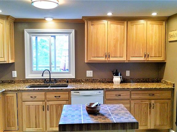 A gorgeous kitchen, beautifully updated with custom hickory cabinets, soft-close cabinet doors, and granite countertops.