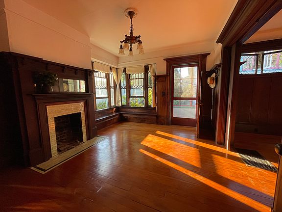 living room with fireplace and pocket doors. Front door pictured.