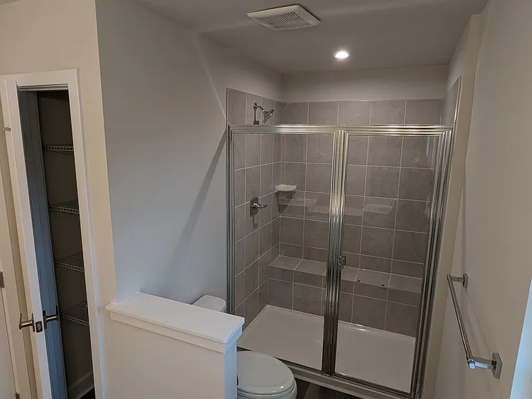 owner's suite bathroom with linen closet