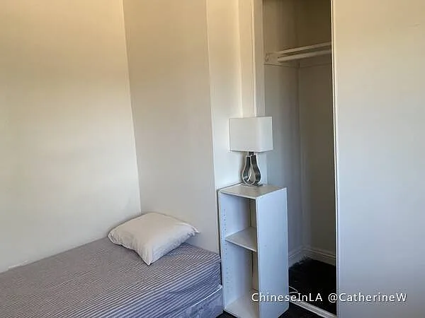Bedroom 1. Spacious closet, lamp, shelf.