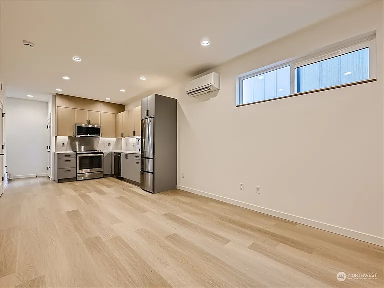 Living room. Ideal TV location is on opposite wall. Shelving has since been added for additional storage!