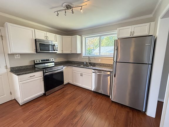 Freshly painted updated kitchen with stainless steel appliances