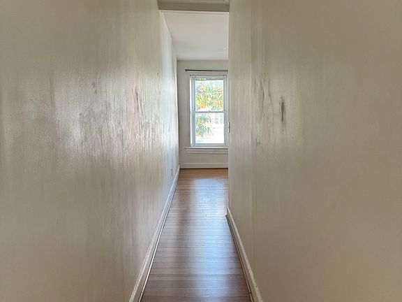 hallway separates kitchen and living room