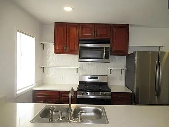 large kitchen island, Stainless steel appliances, French Door refrigerator