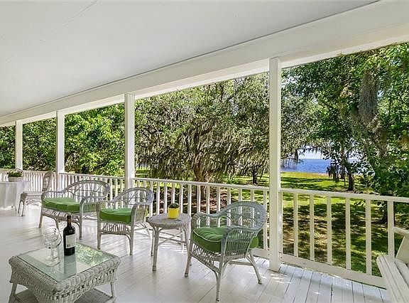 10 foot deep front porch overlooking the beautiful Lake. Allow your worries to blow away in these delightful breezes.