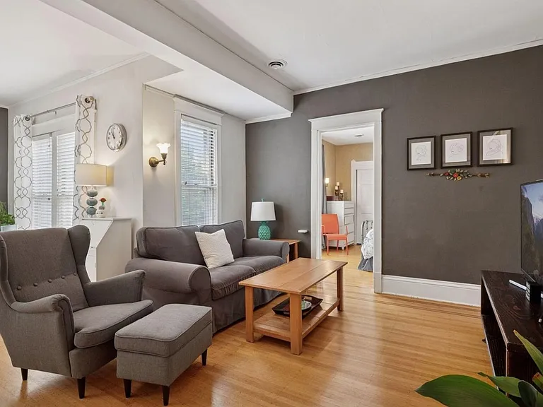 Spacious living room. Great condition hardwood floors, neutral paint colors.
