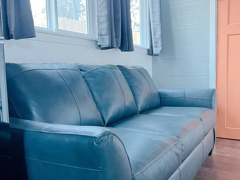 TV can be seen from all areas of tiny home and bed