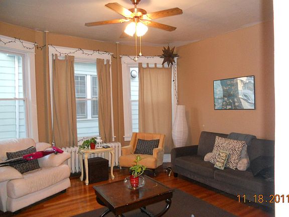 Living room with ceiling fan and hardwood floors