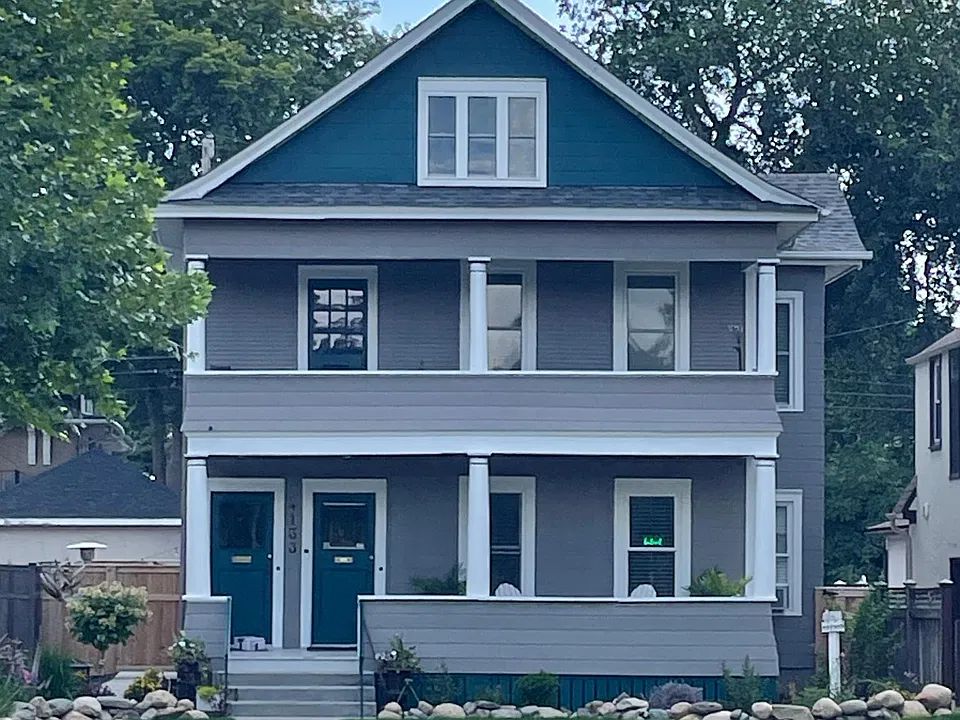 Front of house with new fenced in backyard