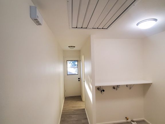 Whole house attic fan, roomy laundry hookups, and side door to fenced shaded private yard