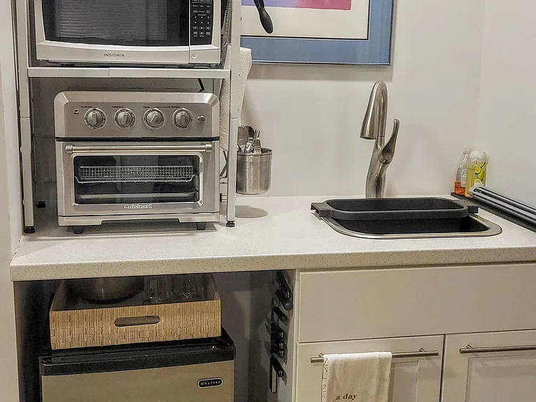 Fully equipped kitchenette with large sink and fridge.