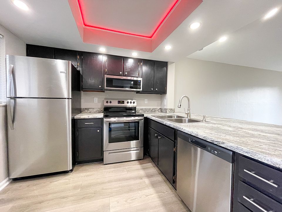 Chef-inspired kitchen with stainless steel appliances and a color-changing ceiling light.