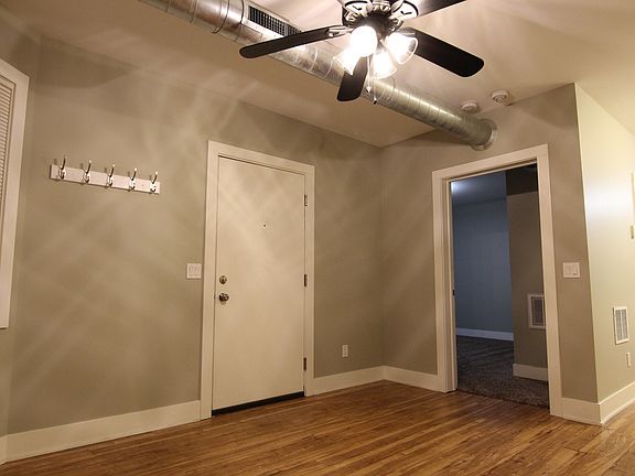 Living room view looking at the main entrance into the apartment and the bedroom.