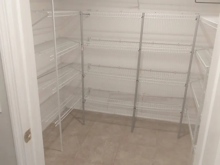 Full size walk in food pantry with electric plug inside and space for ice maker, or deep freezer etc. Located in hallway right next to kitchen.