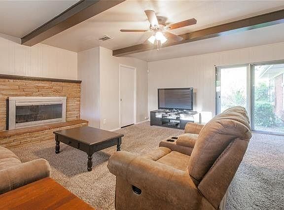 Family / TV addition next to kitchen. Gas burning fireplace. Will install new rug.