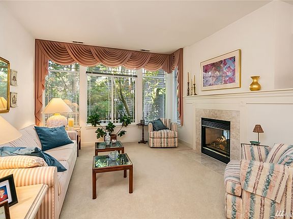 Elegant living area with dual sided fireplace opens to dining room.