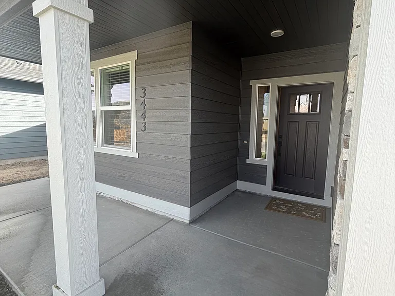 Enjoy the covered front porch, offering a welcoming space to relax, unwind, and enjoy the outdoors while being protected from the elements. It's the perfect spot for morning coffee or greeting guests.