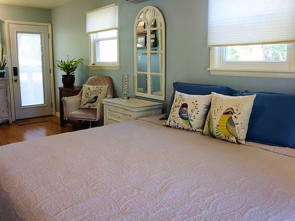 The door goes out to a back deck with a grill, seating, and a fire pit. A lovely field is behind the house, with no neighbors back there.