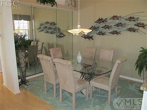Dining Room with large mirrored wall.