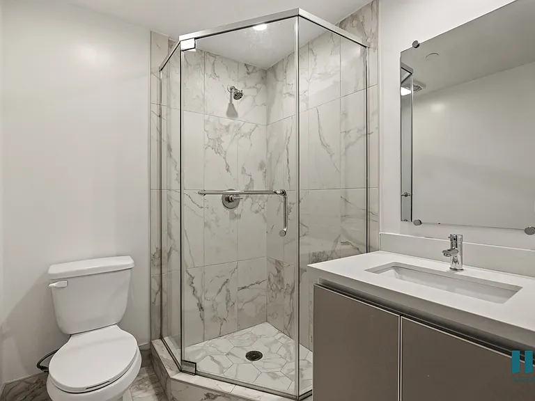 Bathroom with Stand-Up Shower with Glass Door and Vanity Cabinet Storage