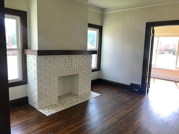 Brick Fireplace with Marble & Travertine Herringbone Tile
