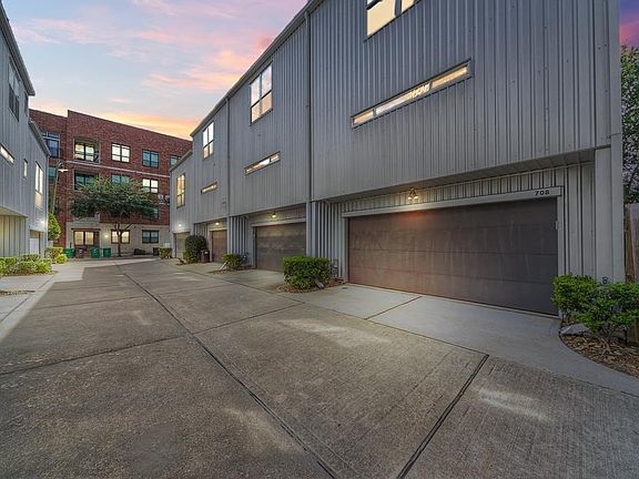 1ST FLOOR BEDROOM W/ RECENTLY STAINED CONCRETE. SLIDING DOORS LEAD TO THE PRIVATE FRONT PATIO!