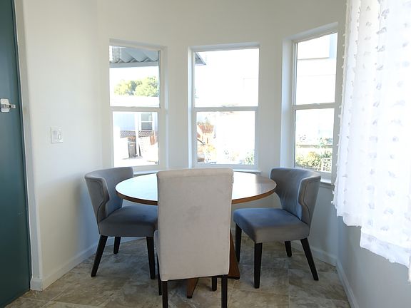 Dining table with chairs. Big windows for light and view.