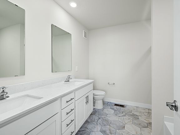 The master bathroom has a dual sink vanity