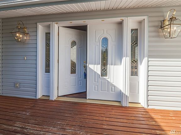 Elegant dual coach light grace the double front doors.