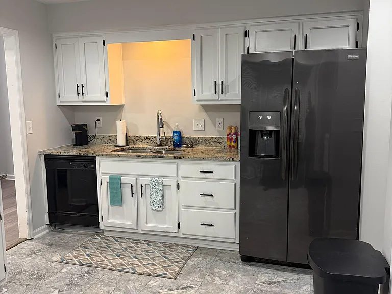 Kitchen features generous cabinet storage, granite-look counters, a dishwasher, and a side-by-side fridge with ice/water.