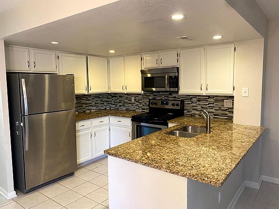 Updated kitchen with granite countertops and stainless steel appliances