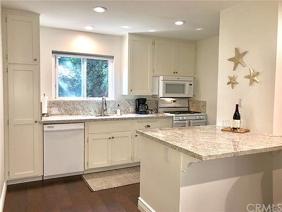 Roomy Kitchen with breakfast bar,gas range and lovely very private window view.