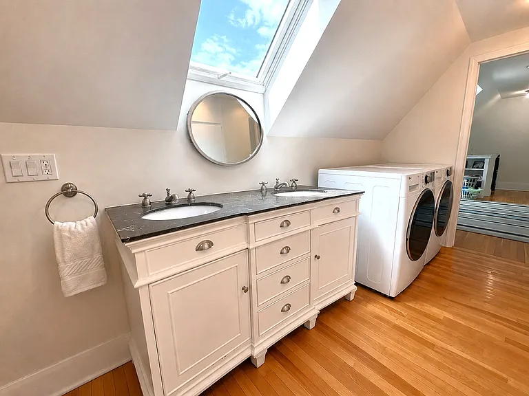 2nd level bathroom with double vanity and washer/dryer