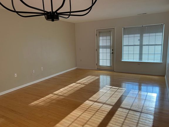 View of LIving Room from Kitchen Bar - Maple Hardwood Floors - Door to screen porch.