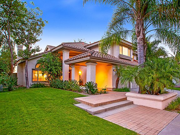 The perfectly manicured yard starts in the front yard and extends to the back