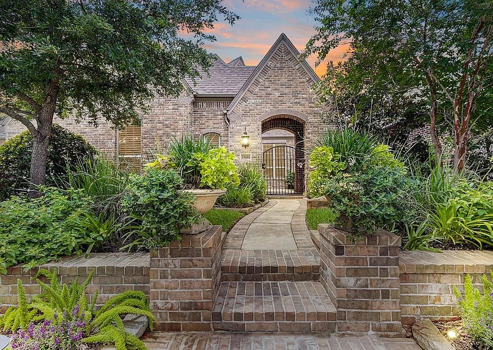 An elegant path with gorgeous landscaping to welcome your guests.